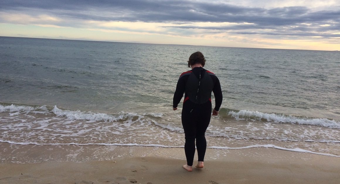 Phillipa at the beach in a wetsuit to combat the suffering of TSW