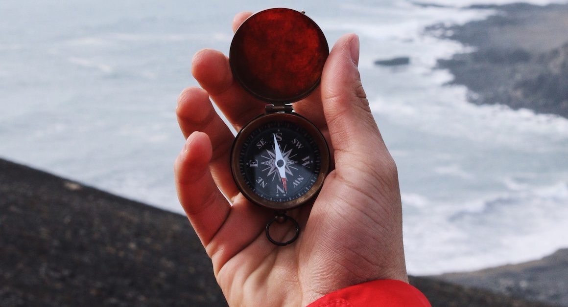Person navigating with a compass